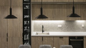 A modern kitchen with pendant lighting, a built-in wine rack, and a central island. - Deluxe & Upscale Apartment in Athens (Athens)