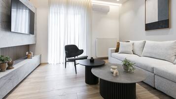 Luxury Apartment, 3 Bedrooms, Air conditioning | Living area | 50-inch flat-screen TV with cable channels