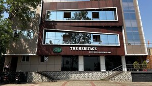 A two-story building with a sign reading "THE HERITAGE FINE DINE RESTAURANT". - The Heritage (Dumka)