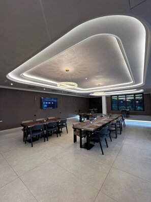 A modern conference room with a large table, chairs, and a flat-screen TV on the wall. - Nobel West Hotel (Belgrade)