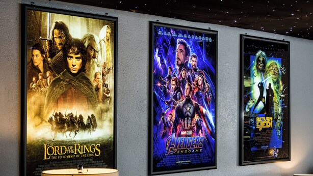 A wall with movie posters, including 'The Lord of the Rings: The Fellowship of the Ring' and 'Avengers: Endgame'.