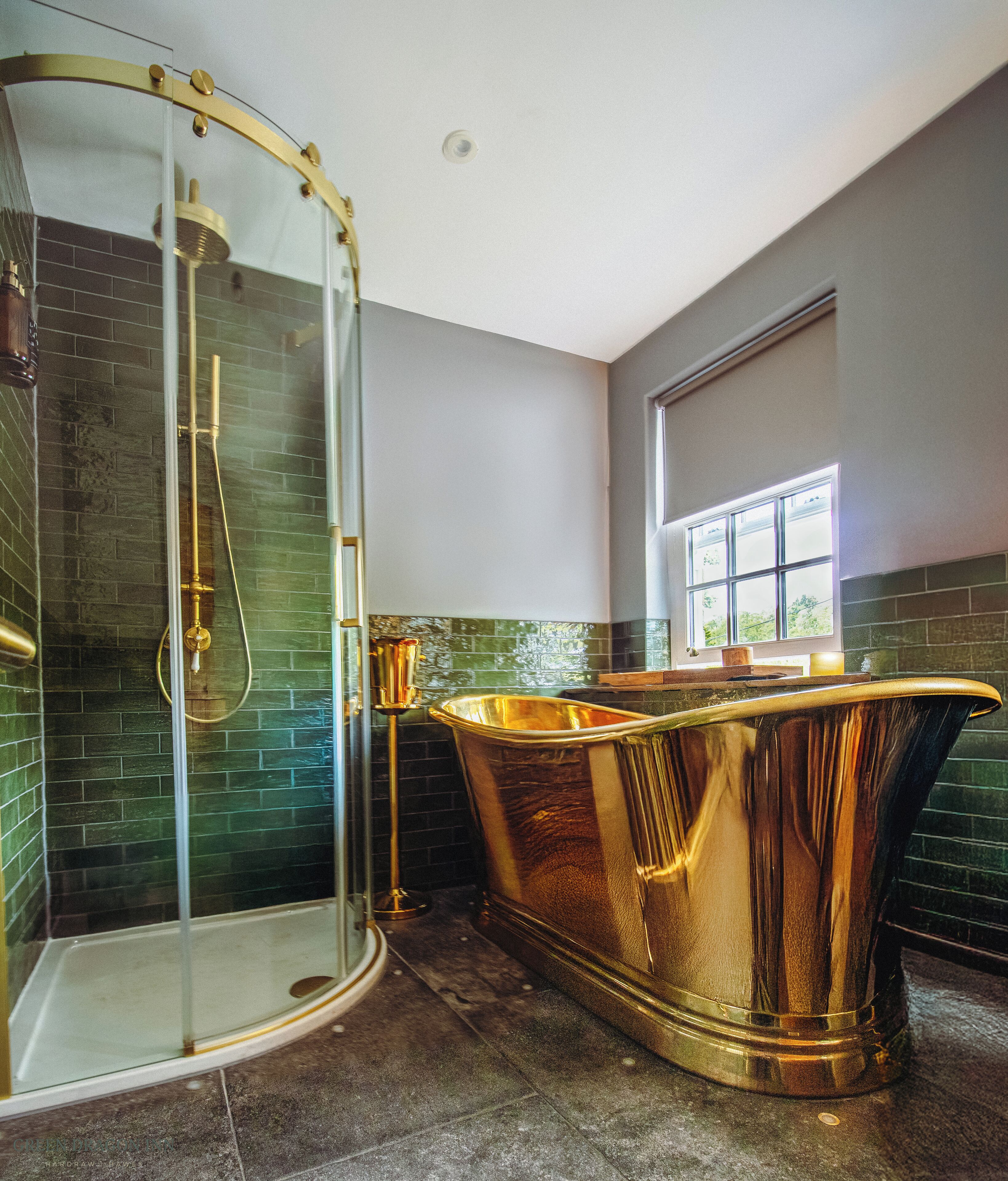 A bathroom with a glass-enclosed shower, a freestanding bathtub, and a window providing natural light.
