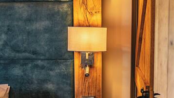 A wall-mounted lamp with a wooden panel and a switch.