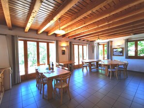 Enjoy meals in this dining area with high ceilings, large windows, and a television.
