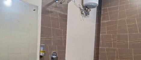 A bathroom with a sink, toilet, and shower.