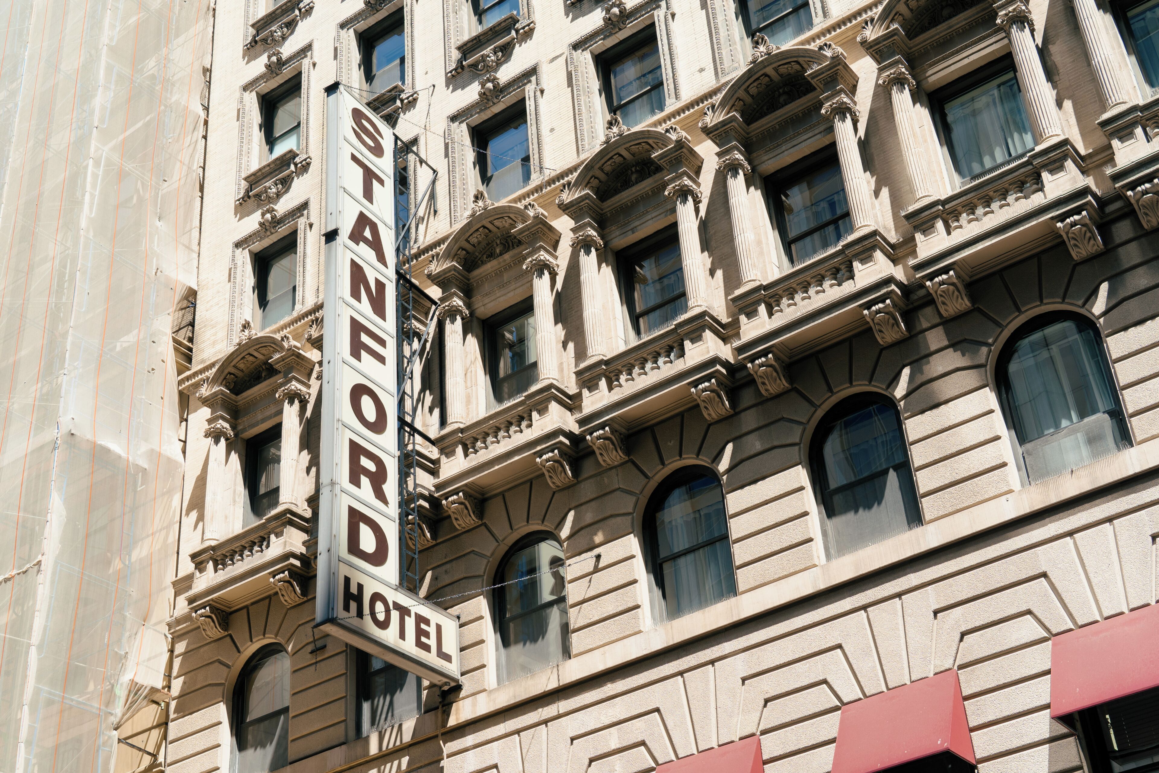 A building with a sign that reads 'Stanford Hotel.'