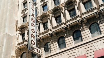 A building with a sign that reads 'Stanford Hotel.'