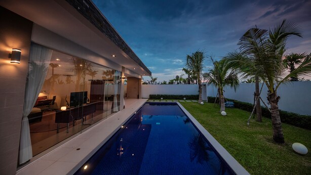 A modern house with a swimming pool, glass doors, and a well-maintained lawn. - Angkor Rendezvous (Siem Reap)