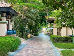Stroll through lush gardens surrounded by traditional architecture and serene greenery.