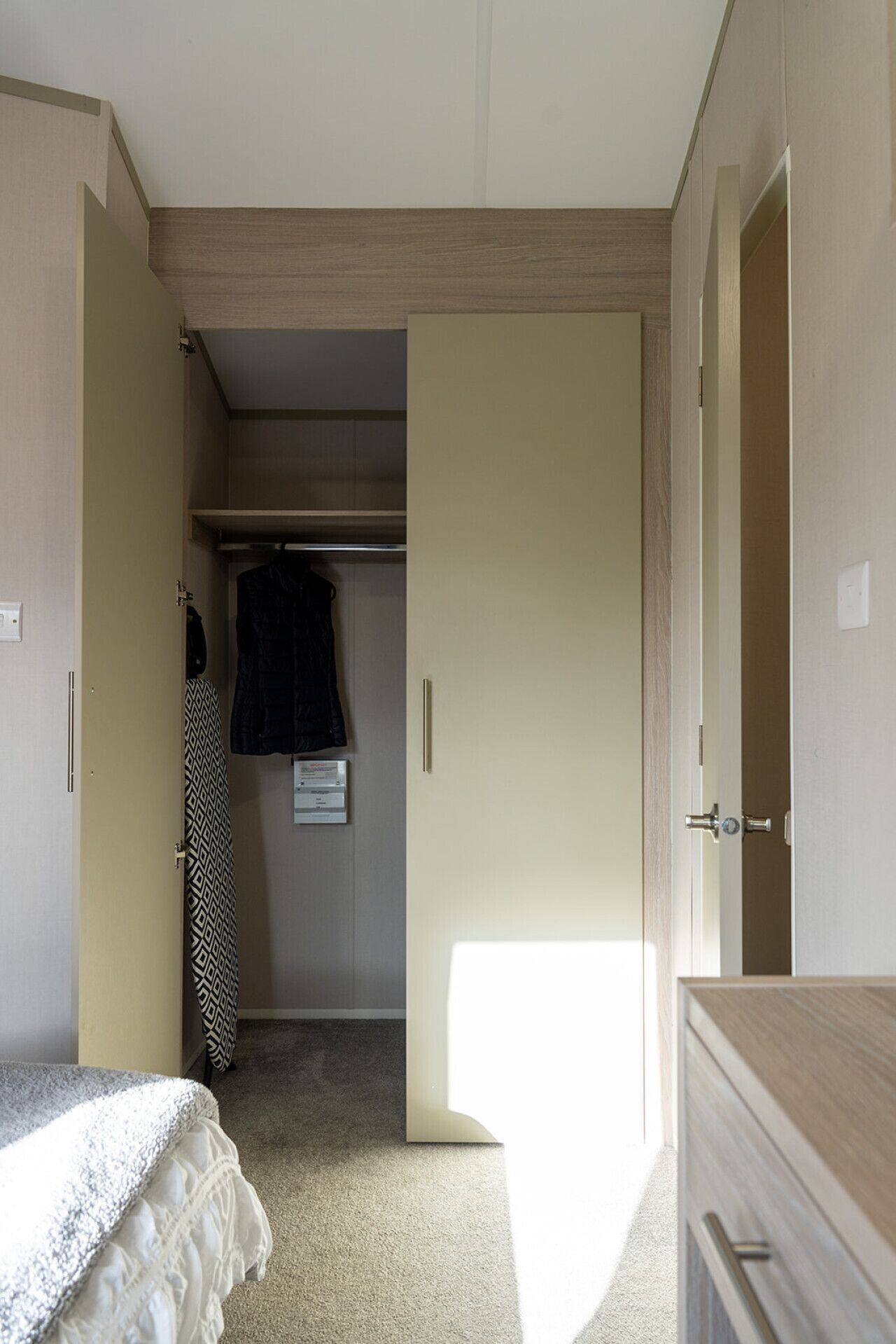 A bedroom with a bed, a wardrobe, and a closet.