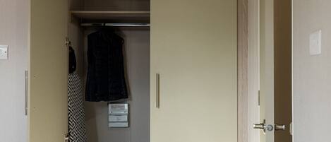 A bedroom with a bed, a wardrobe, and a closet.
