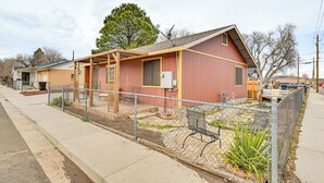 A small, single-story building with a red exterior and a wooden porch. - Downtown Williams Home: Walk to Shops & Dining! (Williams)