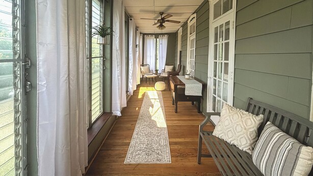 A covered porch with a wooden floor, a bench, and two chairs. - Pet & Family Friendly! Home w/ Fenced Yard + Deck (York Haven)