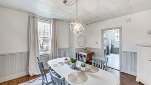 A dining room with a white table, grey chairs, and a hanging light fixture. - Pet & Family Friendly! Home w/ Fenced Yard + Deck (York Haven)