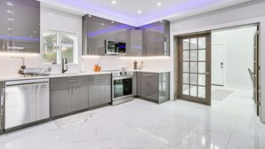 A modern kitchen with stainless steel appliances, a built-in oven, and a microwave.
