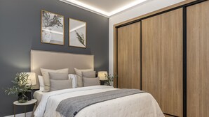 Un dormitorio con una cama grande, mesitas de noche, un armario y una obra de arte en la pared.