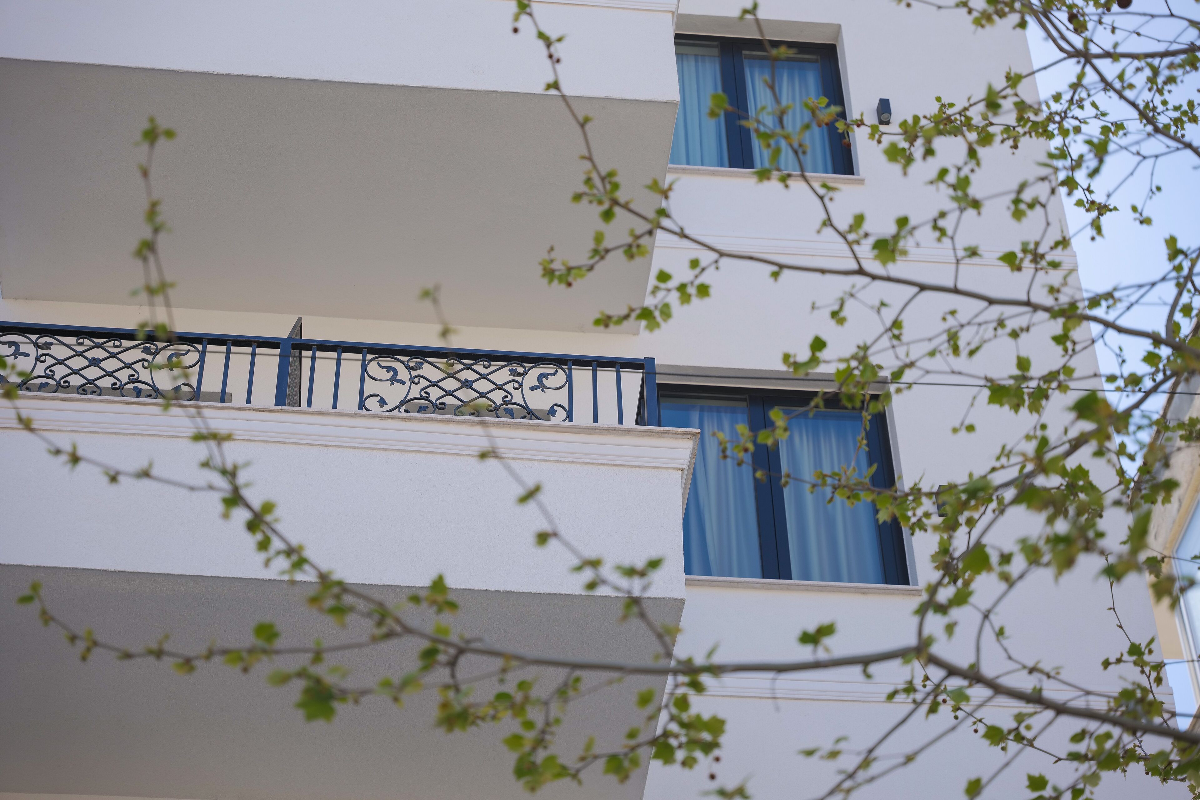 A multi-story building with balconies and windows.