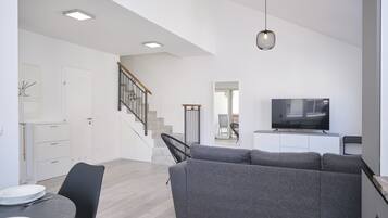 Apartment, Balcony, Bay View | Living area | 60-inch Smart TV with cable channels