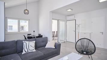 Apartment, Balcony, Bay View | Living area | 60-inch Smart TV with cable channels