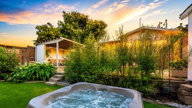 A hot tub in a backyard with a wooden deck, steps, and a covered seating area. - 25% Off Sept 10-13 Mins 2 Beach, Great 4 Families! (Ventura)