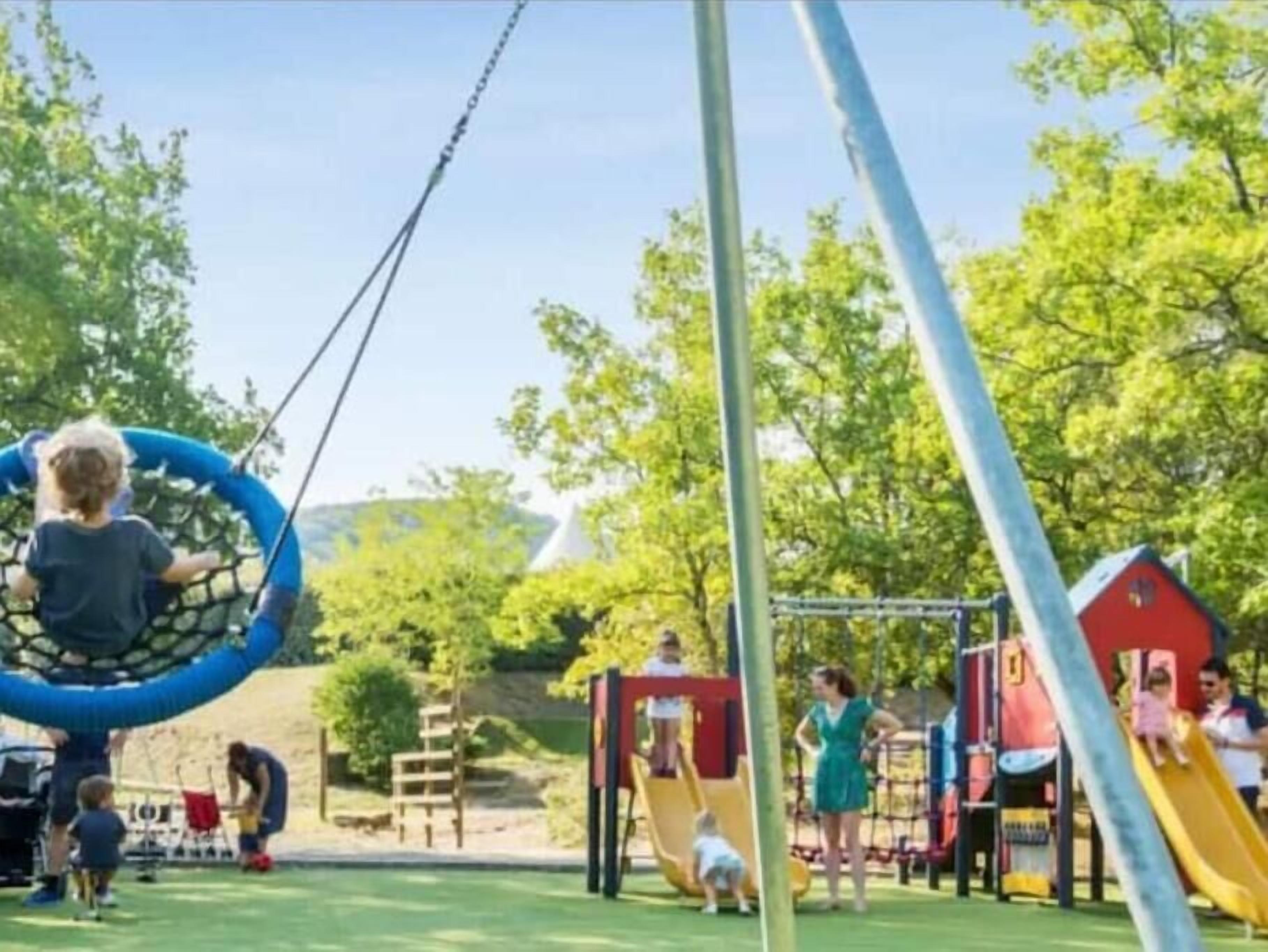 A playground with swings, slides, and climbing structures.