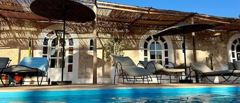 Outdoor pool, open 10:00 AM to 8:00 PM, pool umbrellas