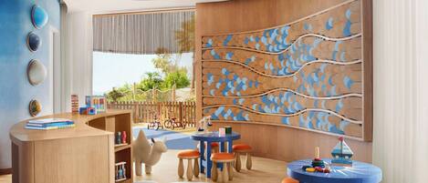 A children's playroom with a wooden desk, colorful chairs, and a large wall mural.