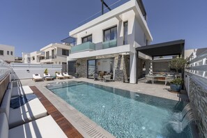 Relax by the outdoor pool and enjoy the covered patio with a dining area.