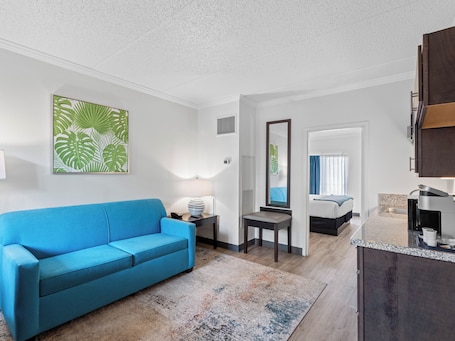 Executive King Suite | Living area | 50-inch Smart TV with cable channels. OASIS BAY SUITES, Tampa, Busch Gardens, USF