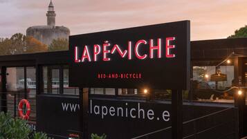 A sign for 'Lapiniche' with a website URL and a tagline 'Bed and Bicycle'.