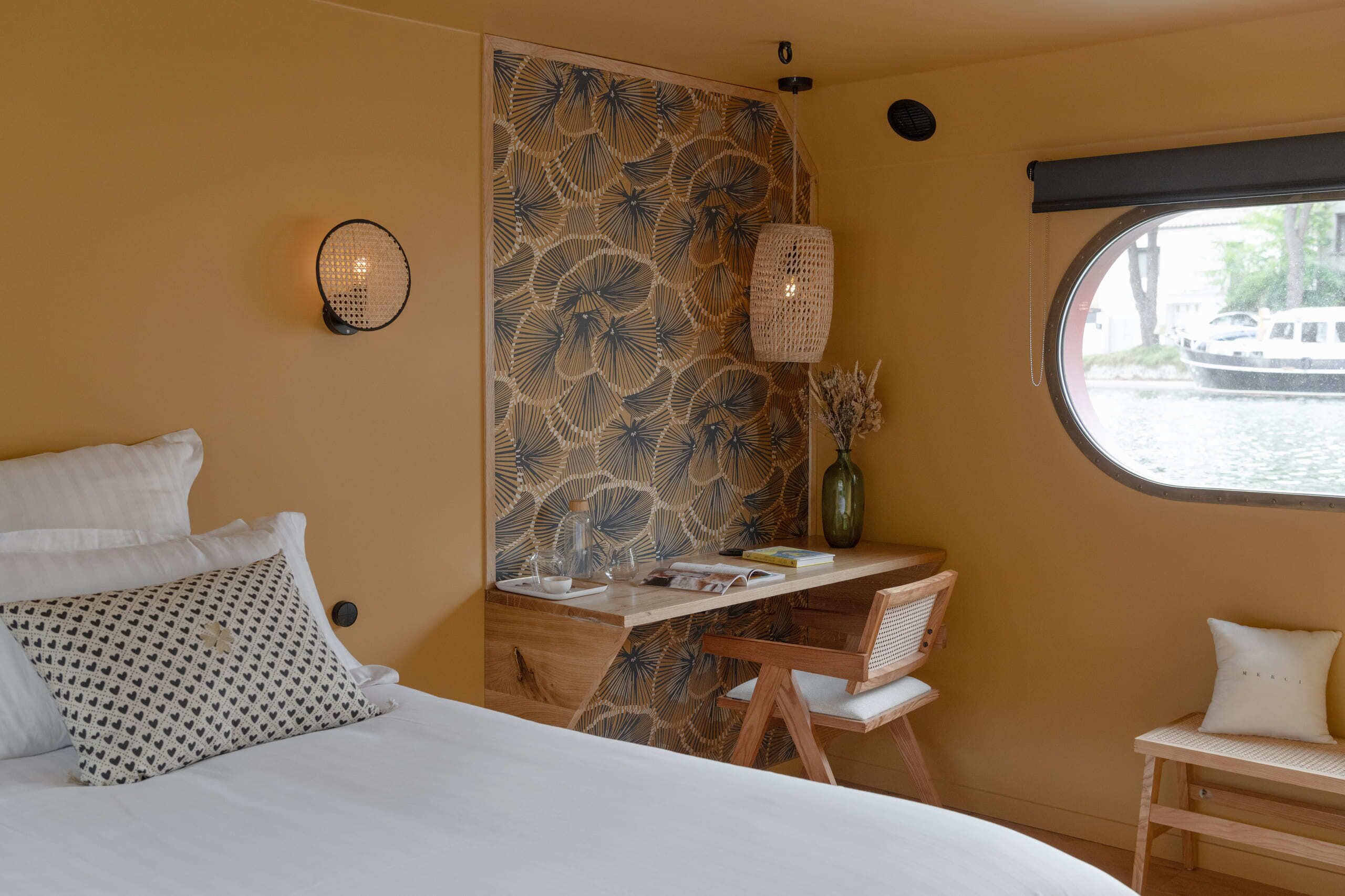 A room with a bed, a desk, and a window.