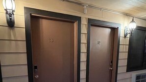 A row of two doors with numbers 13 and 12, each with a small black mat in front. - Frazier View Motel (Frazier Park)