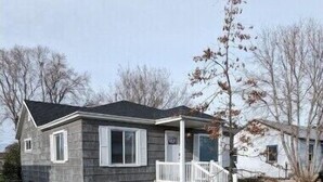 A single-story house with a front porch and a small front yard. - Quaint Murray Home- 2 bed/1 bath  20 min to ski/hike or downtown. 5 min to IMC. (Murray)