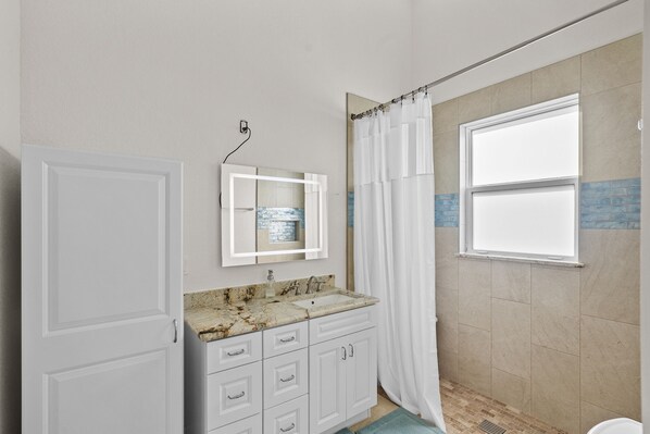 Shower, hair dryer, towels, soap