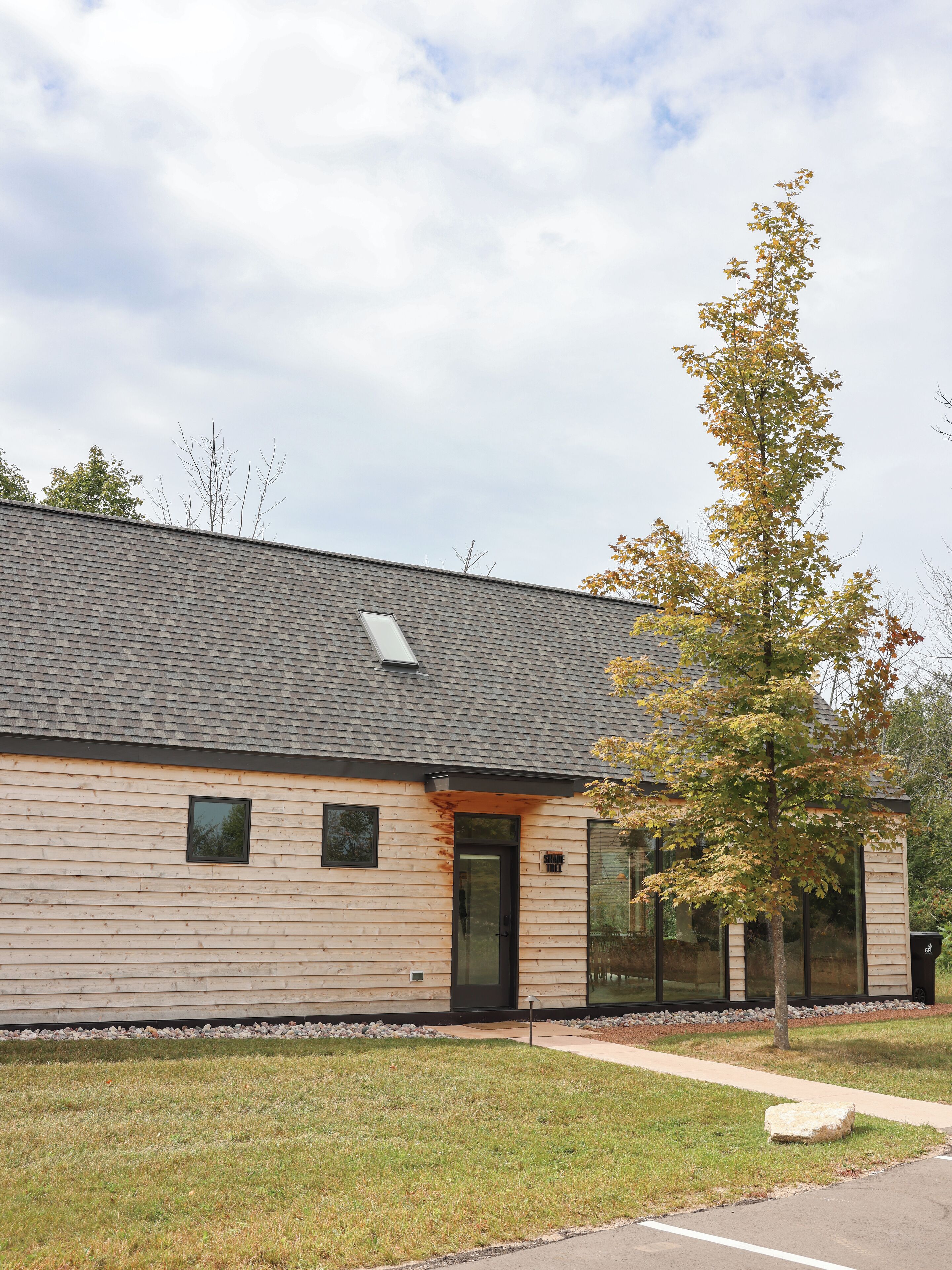 A building with a sloped roof, a small window, and a door.