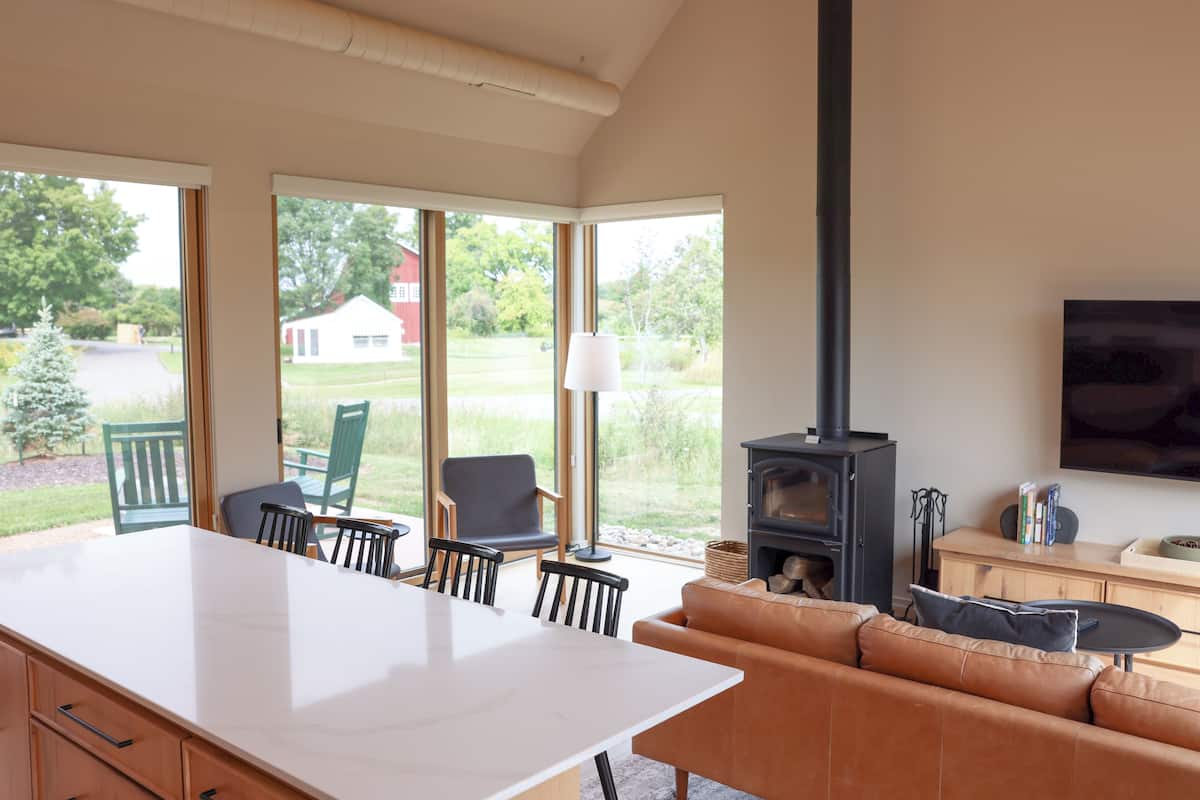 A spacious living area with a large kitchen island, a sofa, and a fireplace.