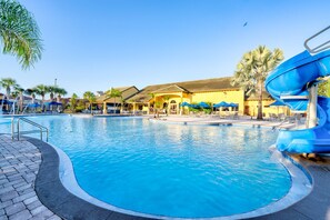 A swimming pool with a water slide, lounge chairs, and umbrellas. - !!Getaway 20 % Deal!!Beautiful Townhome with Private Pool near Disney (Kissimmee)