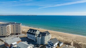 A coastal hotel with multiple buildings, a beach, and a clear view of the ocean. - One bedroom, direct ocean views! (Old Orchard Beach)