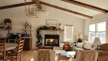 Cozy living space with a fireplace, comfortable seating area, and dining table.