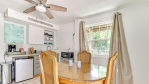 A compact kitchen with a dining area, a ceiling fan, a refrigerator, a microwave, and a coffee maker. - Shared Dock & Fire Pit: Withlacoochee River Gem! (Inglis)