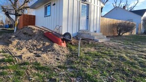 A small, single-story house with a white exterior, a front door, and a small porch. - Tiny home with cabin vibes (Nampa)