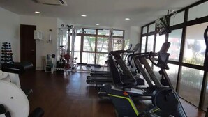 A gym with treadmills, stationary bikes, and weight machines.