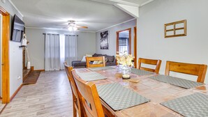 A dining area with a wooden table, chairs, and a ceiling fan. - Quiet & Cozy Rembert Home ~ 9 Mi to Air Force Base (Rembert)
