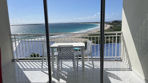 A balcony with a view of the beach and ocean. - French Ocean View , Beach and Pool (Cul-de-Sac)