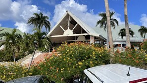 A building with a triangular roof and a large circular window. - French Ocean View , Beach and Pool (Cul-de-Sac)