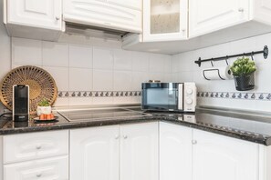 Microwave, stovetop, coffee/tea maker, cookware/dishes/utensils
