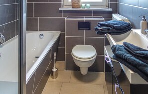 Enjoy a relaxing soak in the bathtub or freshen up at the sink with a wall-mounted bidet.