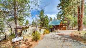 A cabin with a stone exterior, surrounded by tall pine trees, and a clear sky. - Near Hiking: Pet-Friendly Sierra Valley Gem (Loyalton)