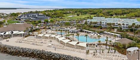 A resort with a pool, beach, and golf course.