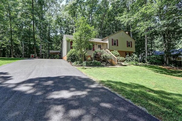 A two-story house with a front yard and a driveway. - LU Commencement Rental - Easy 15 minute drive to LU campus. (Forest)